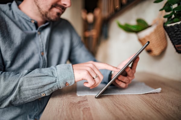 man going through tablet